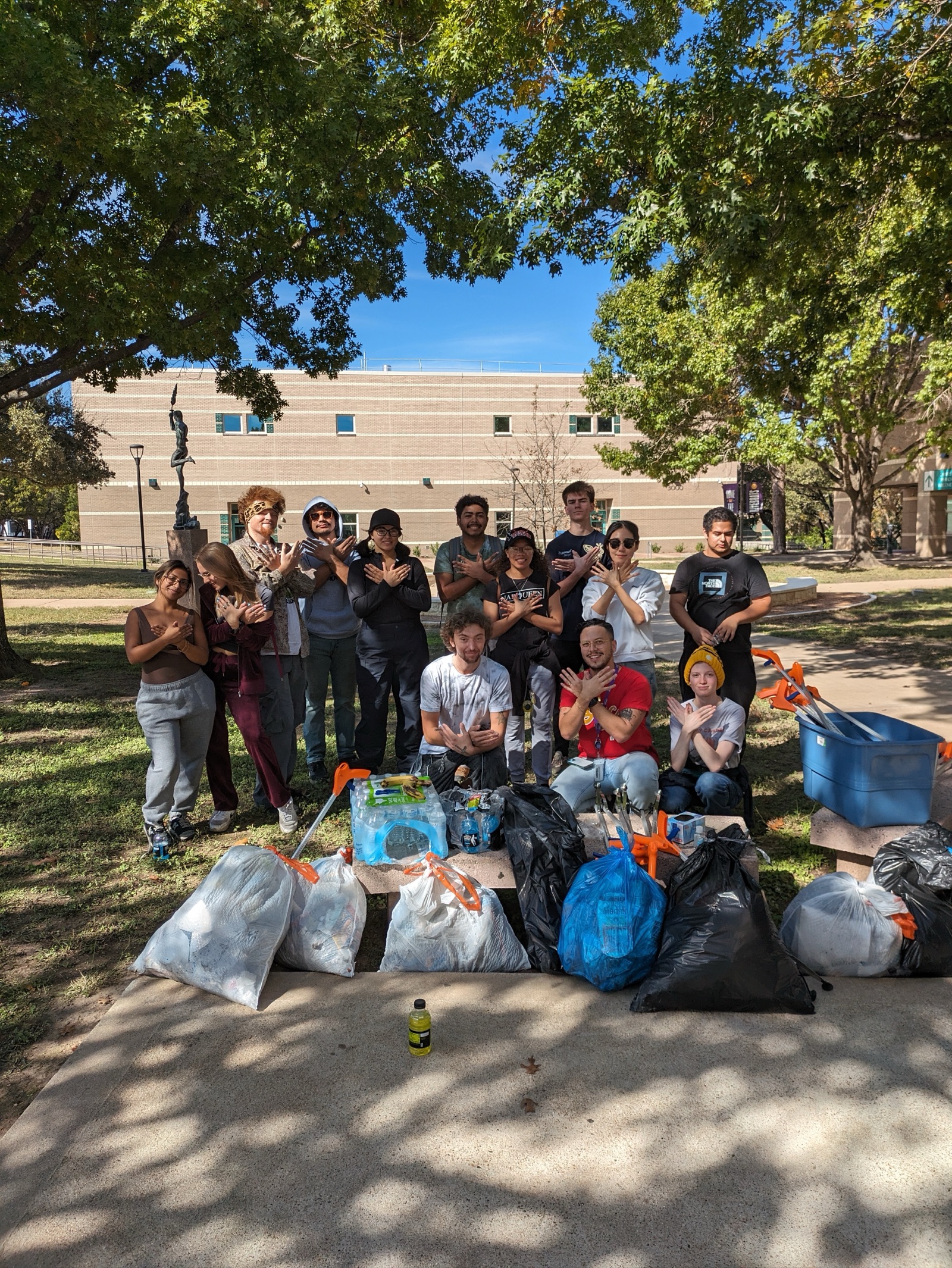 Sustainability Club after a Highland Campus cleanup, posing with bags of collected trash